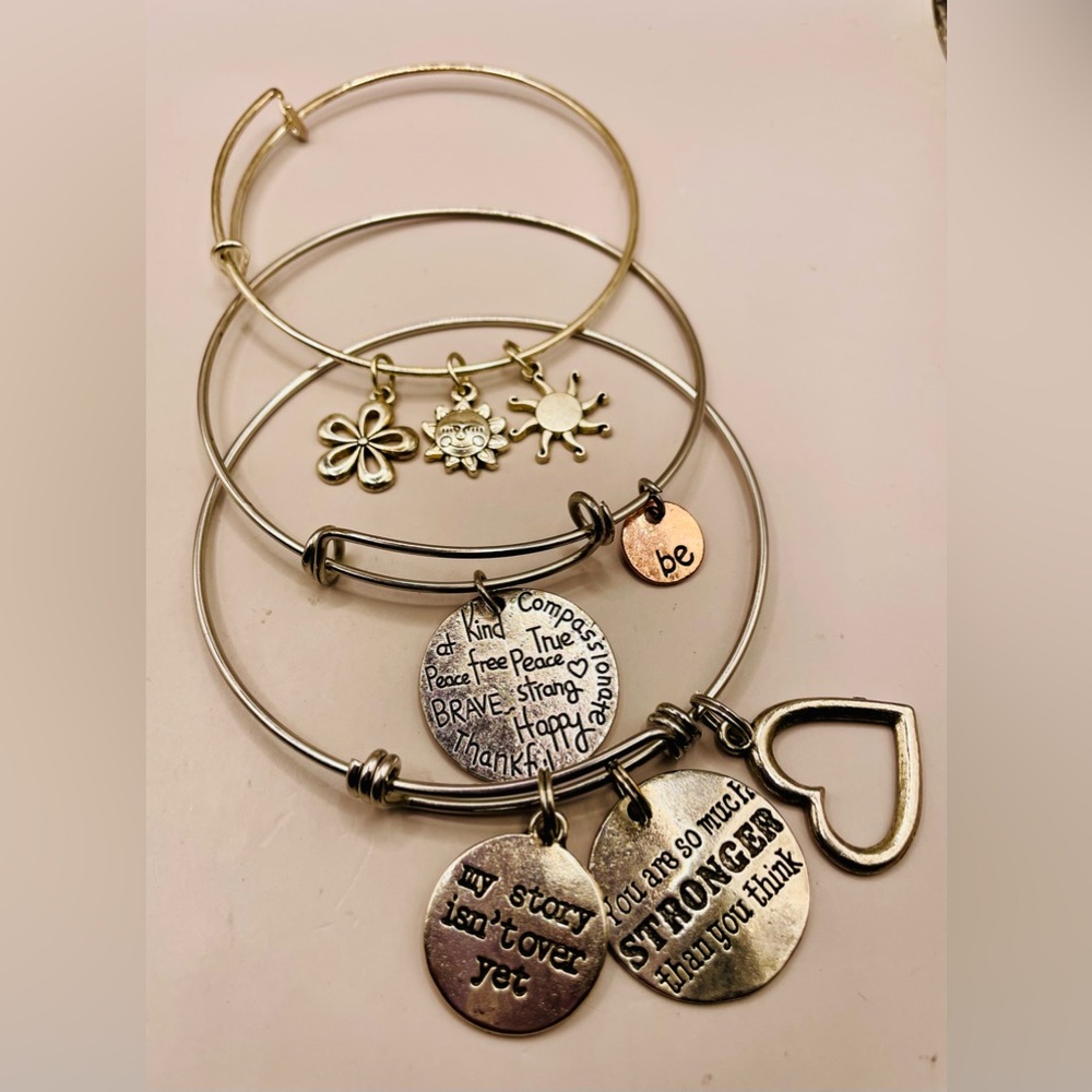 3 silver tone bangle charm bracelets with inspirational quote charms. Expandable